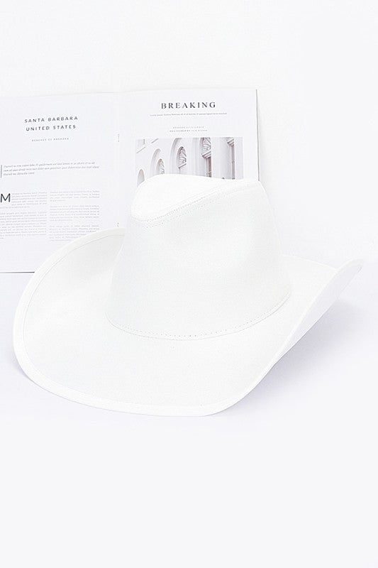 White pillow on a white background with a newspaper in the background