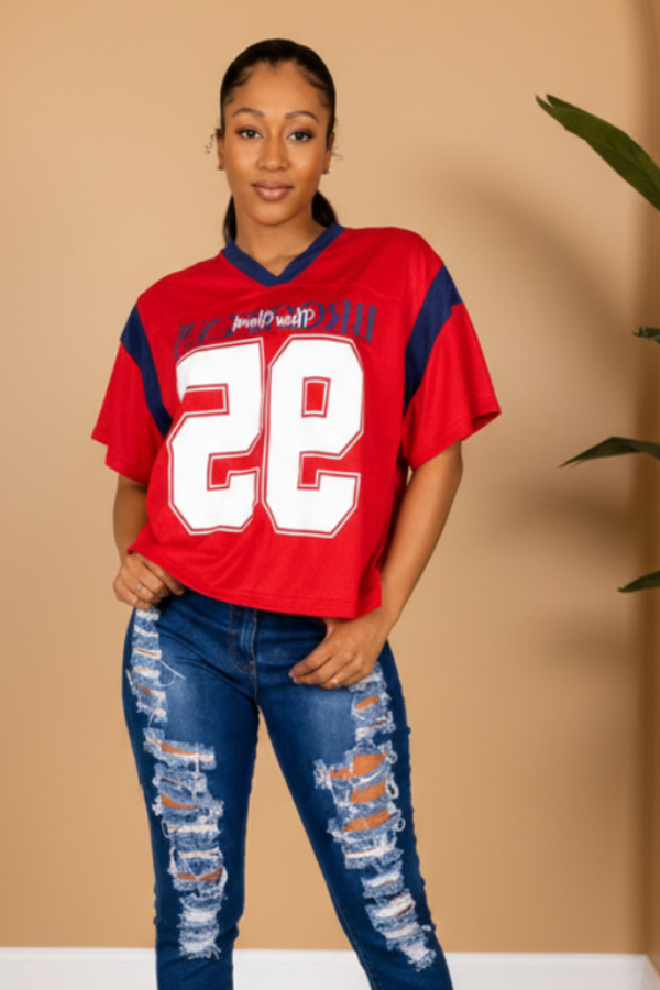 Woman wearing a red sports jersey with the number 22 on a white background