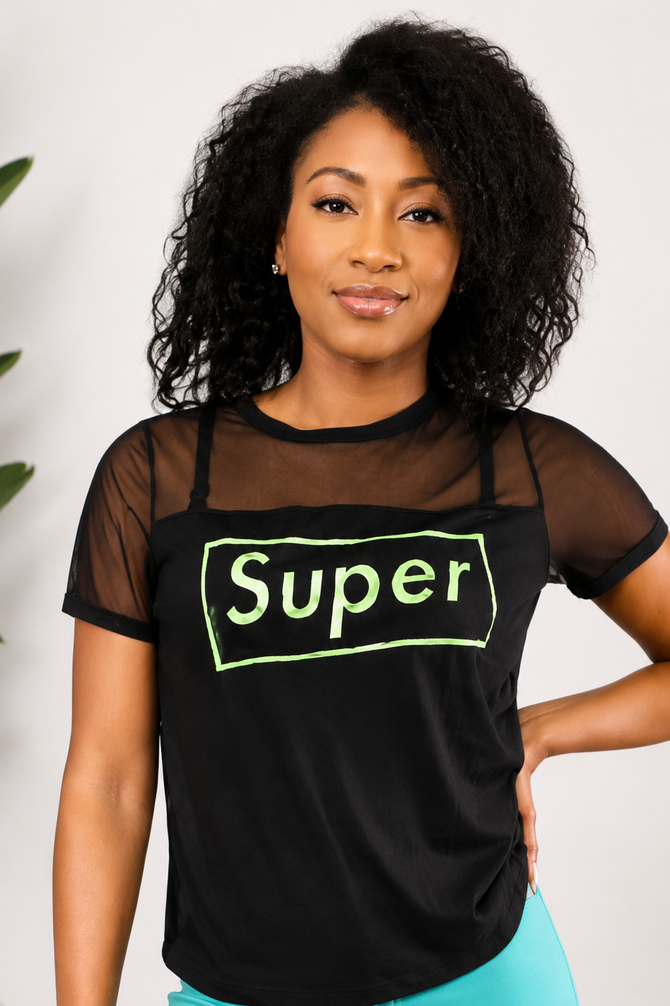 Woman wearing a black t-shirt with 'Super' in green text against a white background Main image