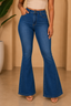 Person wearing blue flared jeans on a beige background