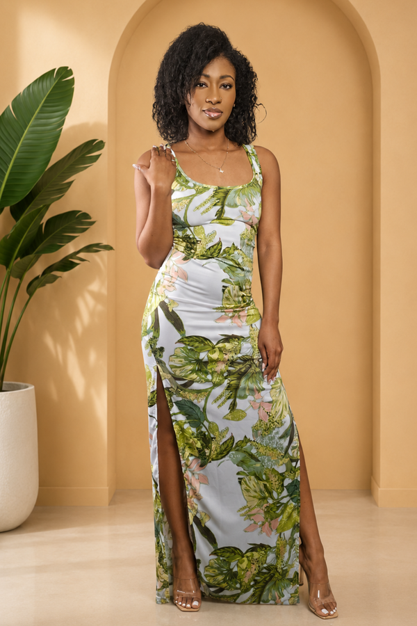 Woman in a floral dress standing in a room with a plant and archway.