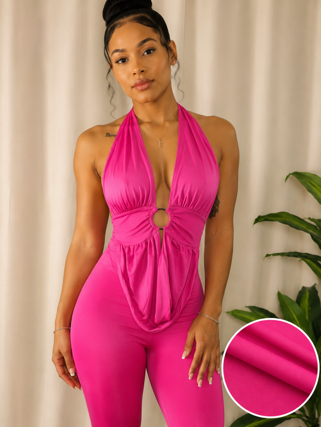 A woman modeling a bright hot pink halter-neck bodysuit with a deep plunging V-neckline, a central keyhole cutout, and a gathered waist. The image features a circular inset in the bottom right corner showing a close-up of the solid pink fabric texture.