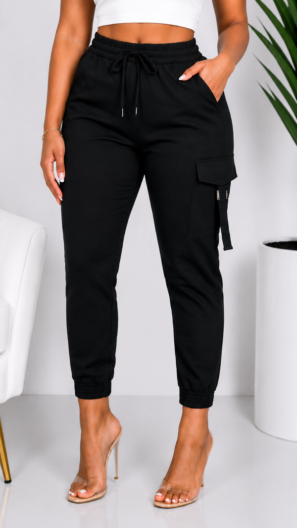 Black cargo jogger pants worn by a person on a white background